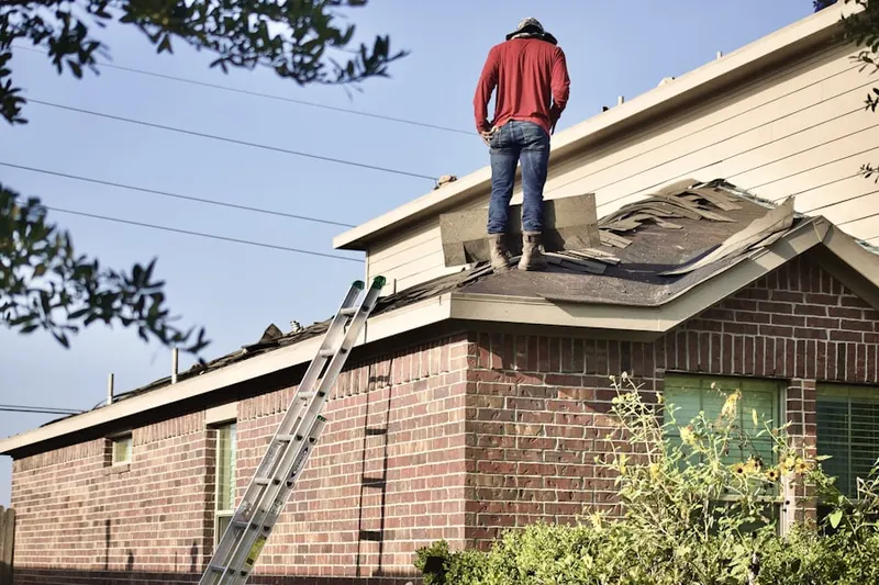 Professional roofer working on a residential roof in Sheffield Commons
